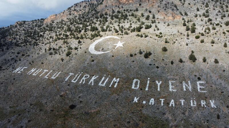 A quote by Turkish Republic founder Mustafa Kemal Ataturk, that reads 'Happy are they who call themselves a Turk', painted on the Kyrenia mountain range in Turkish-held northern Cyprus, where a snap legislative election was held on Sunday. AFP
