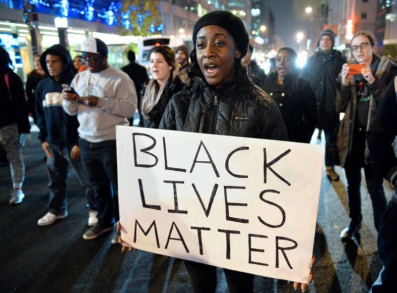 Protesters march on a street in Washington on December 5 during the third night of nationwide protests after a grand jury decided not to charge a white police officer in the choking death of Eric Garner. Mladen Antonov / AFP Photo

