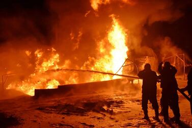 Syrian fire fighters and civil defence teams put out a fire after an explosion at an oil refinery in the central province of Homs. EPA