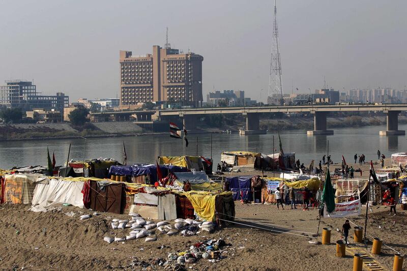 Iraqi demonstrators rest under al-al-Jumhuriyah Bridge spanning the River Tigris and leading towards the highly secured Green Zone in the heart of Baghdad.   AFP