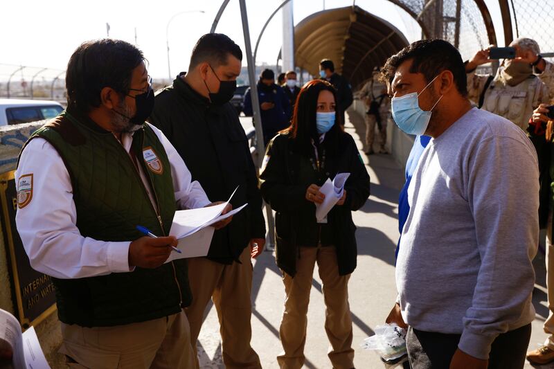 Migrants under the Migrant Protection Protocols (MPP) programme are met by agents of the National Migration Institute of Mexico at the Lerdo-Stanton International Bridge to continue with their asylum application. Reuters