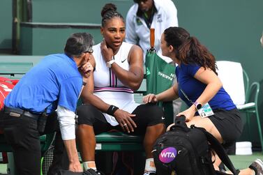 Serena Williams receives medical attention after she retired in the second set of her third round match against Garbine Muguruza. Reuters