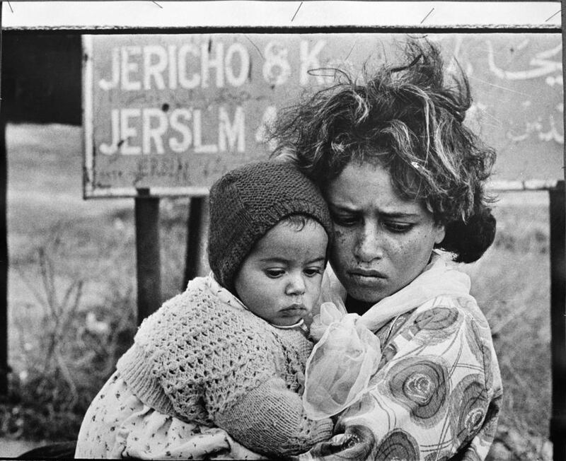 This picture taken in 1968 shows Palestinian refugees arriving in east Jordan in a continuing exodus of Palestinians from the West Bank and Gaza Strip. The partially obscured signboard reads ‘Jericho 8 km, Jerslm (Jerusalem) 43 km’. AP Photo/G.Nehmeh, UNRWA Photo Archives