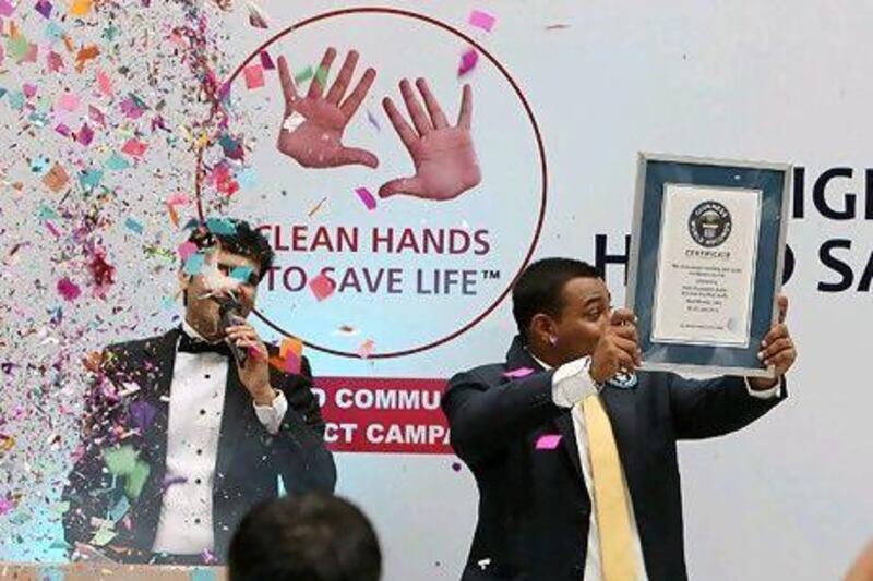 Nikhil Shukla, Guinness World Records India representative, shows the Guinness World Records certificate after the Clean Hands to Save Life campaign at the Centre One Mall in Vashi in Navi Mumbai on Friday.