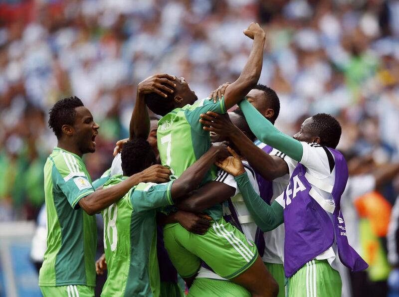 Nigeria's Ahmed Musa, centre, celebrates with his teammates after scoring their second goal against Argentina on Wednesday at the 2014 World Cup in Porto Alegre, Brazil. Darren Staples / Reuters