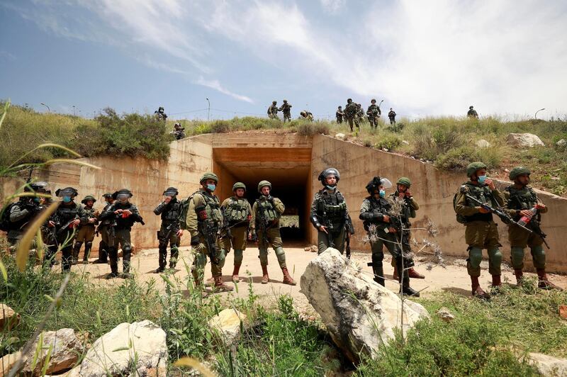 Israeli troops stand guard as Palestinians marking the 72nd anniversary of Nakba and protest against Israeli plan to annex parts of the occupied West Bank, in the village of Sawiya near Nablus May 15, 2020. Reuters