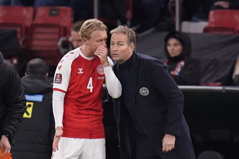 Denmark manager Kasper Hjulman talks to Simon Kjaer during the game in Copenhagen. EPA