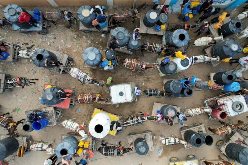 Palestinians collect water, of which there is an acute shortage in the Gaza Strip, from a desalination plant. Reuters