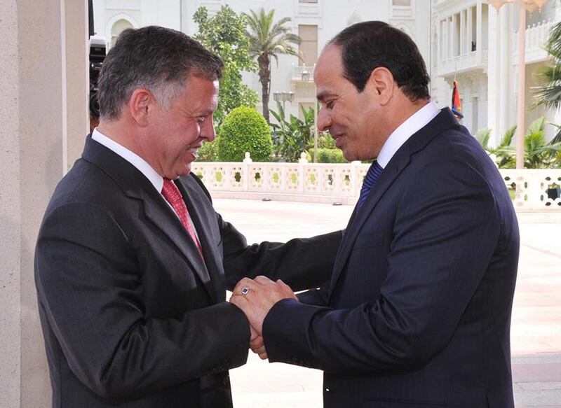 Handout picture from the Jordanian Royal Palace shows Jordan’s King Abdullah II, left, greeting Mr El Sisi, right, at the Presidential Palace in Cairo, Egypt on June 8, 2014 on the day of his inauguration. EPA