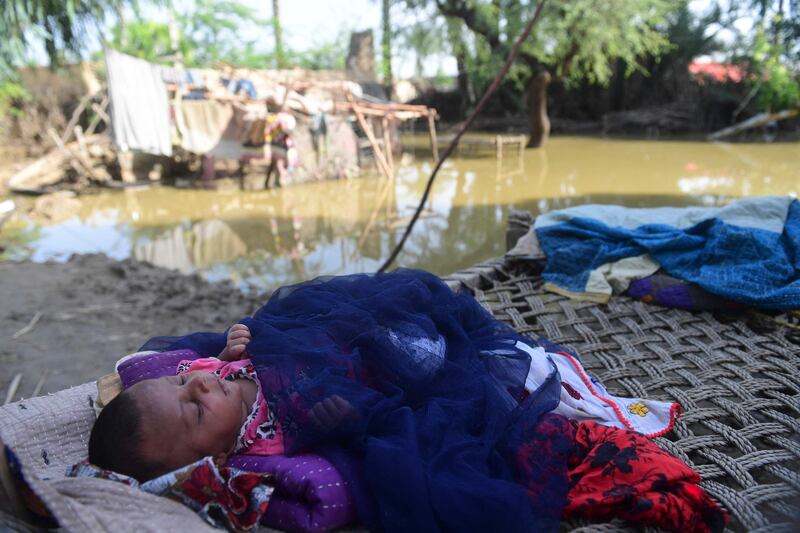 Newborn Yasmeem asleep on a cot at her flood-damaged house on the outskirts of Sukkur, Sindh province. AFP