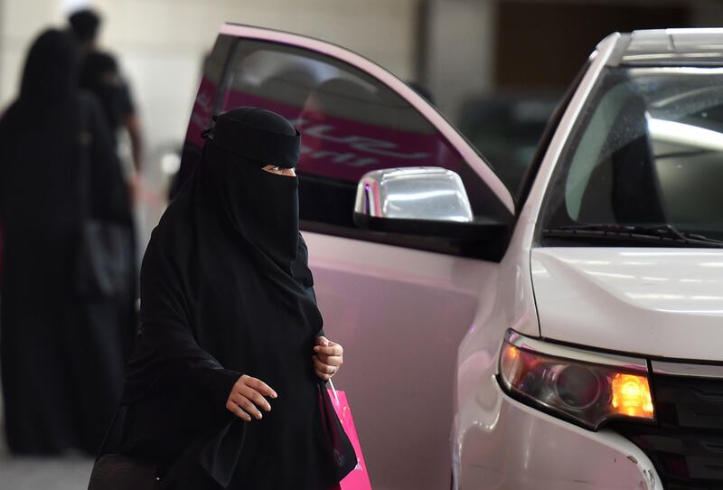 A Saudi woman walks past a car outside a hotel in the Saudi capital Riyadh, on September 28, 2017. 
Saudi Arabia will allow women to drive from June 2018, state media said on September 26, 2017 in a historic decision that makes the Gulf kingdom the last country in the world to permit women behind the wheel. The shock announcement comes after a years-long resistance from women's rights activists, some of whom were jailed for defying the ban on female driving. / AFP PHOTO / FAYEZ NURELDINE