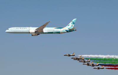 A Boeing 787 Dreamliner owned by Etihad Airways and the Al Fursan aerobatics demonstration team perform during the opening day of the Dubai Airshow 2021. EPA