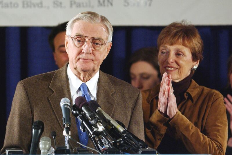 Mondale stands at the podium with his wife Joan as he concedes Senate race to Republican Norm Coleman in 2002. Reuters