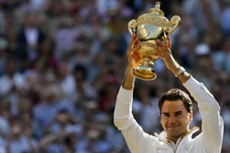 Switzerland's Roger Federer lifts the trophy after beating Andy Roddick in the men's singles final at Wimbledon. It was his sixth victory at SW19.