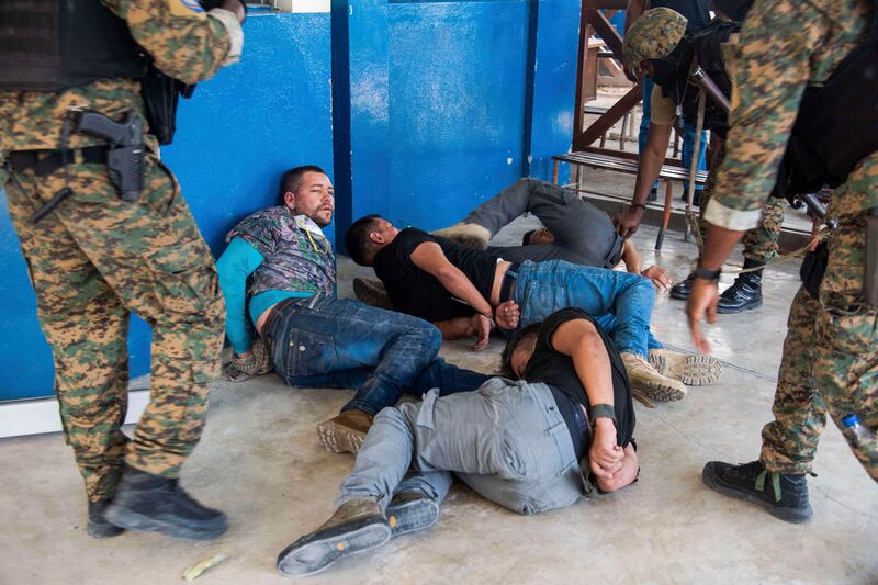 Suspects in the assassination of Haiti's President Jovenel Moise are tossed on the floor after being detained, at the General Direction of the police in Port-au-Prince, Haiti, Thursday, July 8, 2021.  A Haitian judge involved in the murder investigation said that President Moise was shot a dozen times and his office and bedroom were ransacked. ( AP Photo / Jean Marc Hervé Abélard)