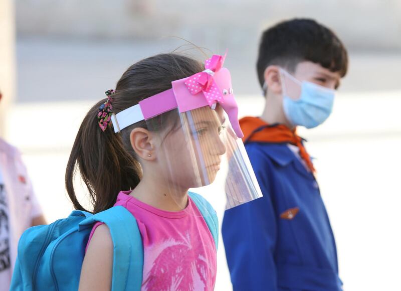 Pupils wearing face shields and masks head to their schools in Damascus, Syria. EPA