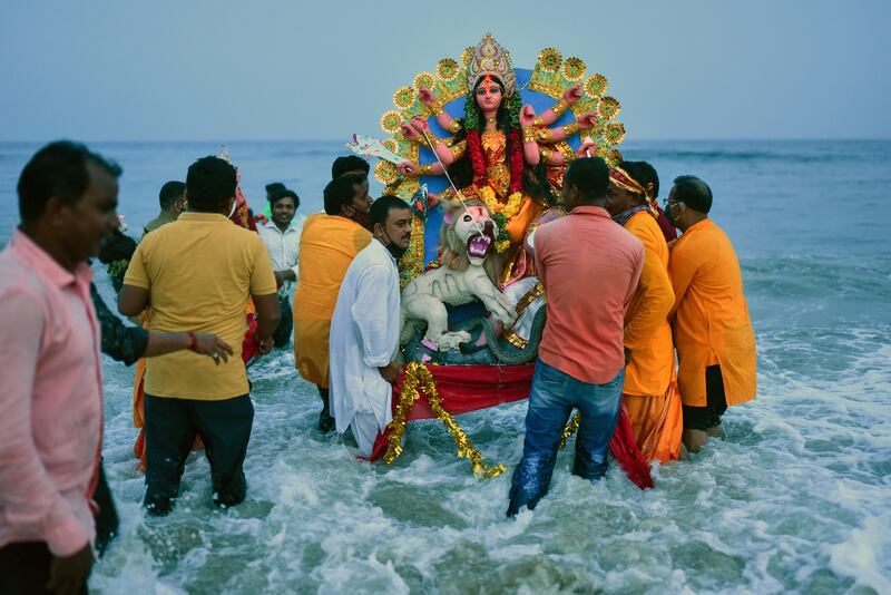 Devotees immerse an idol of the deity Durga into the Bay of Bengal, on the final day of Navratri or Durga puja, at Palavakkam beach in Chennai, India. EPA