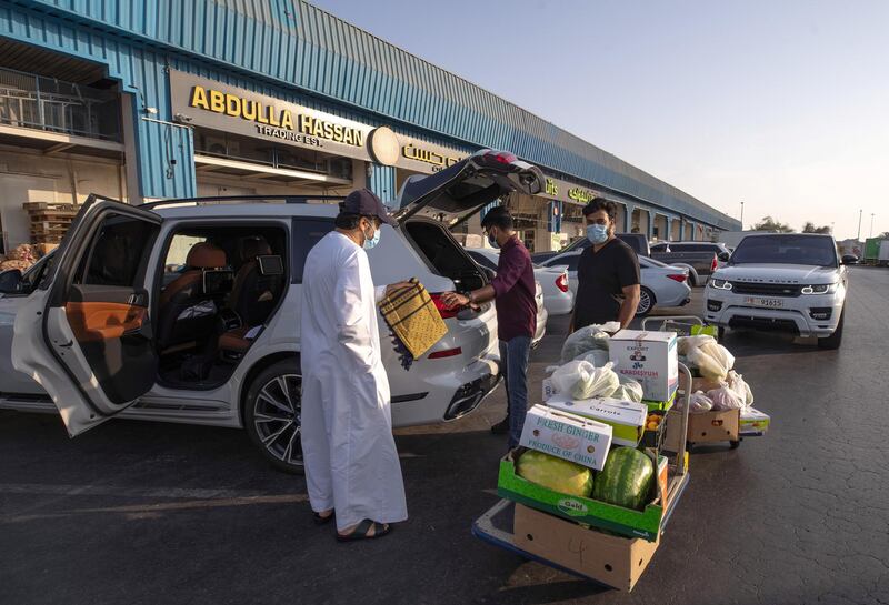 April 26, 2021. Salesmen cart goods to a customers carv at the Abdulla Hassan Trading Establishment, one of the original fruits and vegetable shops in Abu Dhabi which was opened in 1970. Victor Besa / The National.
Section: News/Standalone