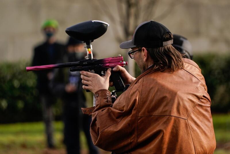 A supporter of President Donald Trump takes aim at counter-protesters during political clashes in Olympia, Washington. AFP