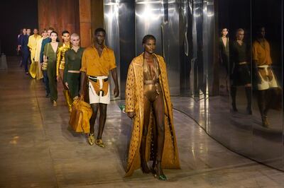 Models parade slinky gold and mustard creations for Bally women's spring/summer 2023 show at Milan Fashion Week on September 24, 2022. AP Photo