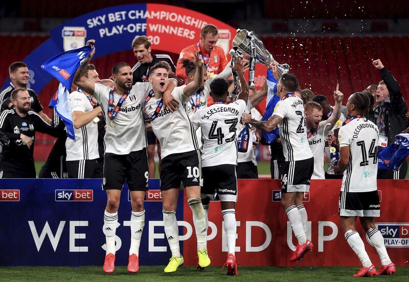 Fulham celebrate with the trophy after winning the Championship play-off final against Brentford and securing promotion to the Premier League. PA