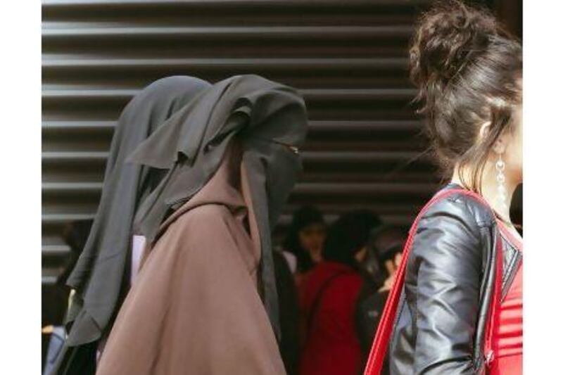 Paris's 200-year-ban on women wearing trousers - an absurd law that was lifted this week - was never equivalent to the French law that bans full face veils, a reader argues. Joel Saget / AFP