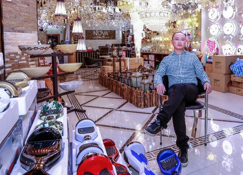 “My family is here, my business is here so my home is here,” says Lejun Bao, who runs a shop at Dubai’s Dragon Mart. Victor Besa for The National
