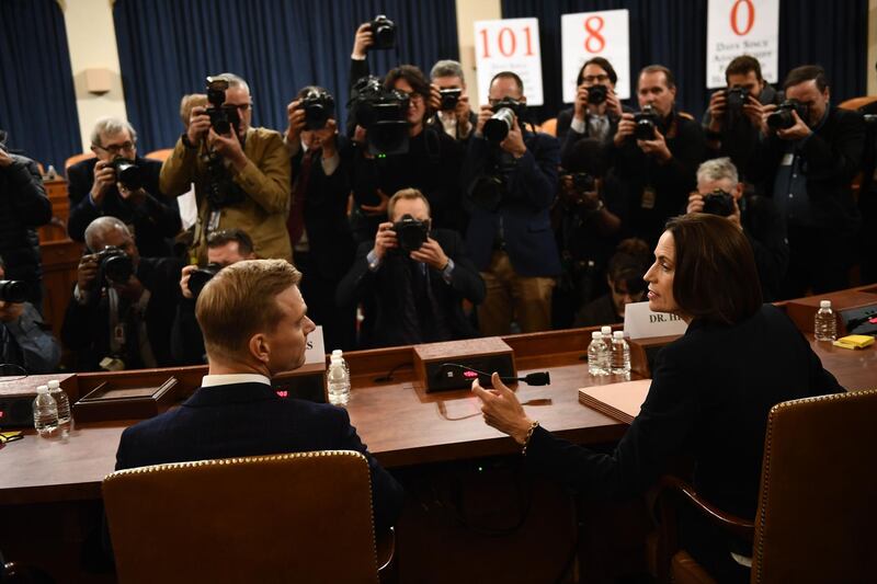 Fiona Hill, the former top Russia expert on the National Security Council, and David Holmes, a State Department official stationed at the US Embassy in Ukraine speak before they testify during the House Intelligence Committee hearing as part of the impeachment inquiry into US President Donald Trump on Capitol Hill in Washington,DC on November 21, 2019.    / AFP / Brendan Smialowski
