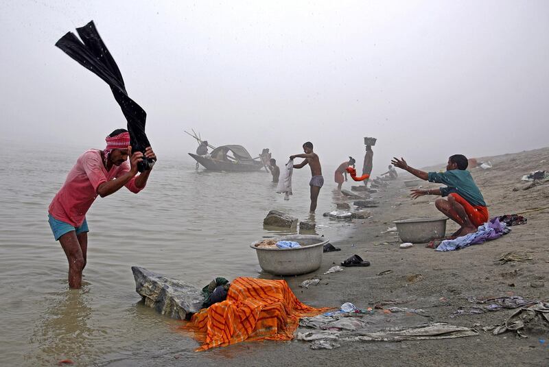 People wash clothes on the banks of the river Brahmaputra on a foggy winter morning in Guwahati, India. Anuwar Hazarika / Reuters