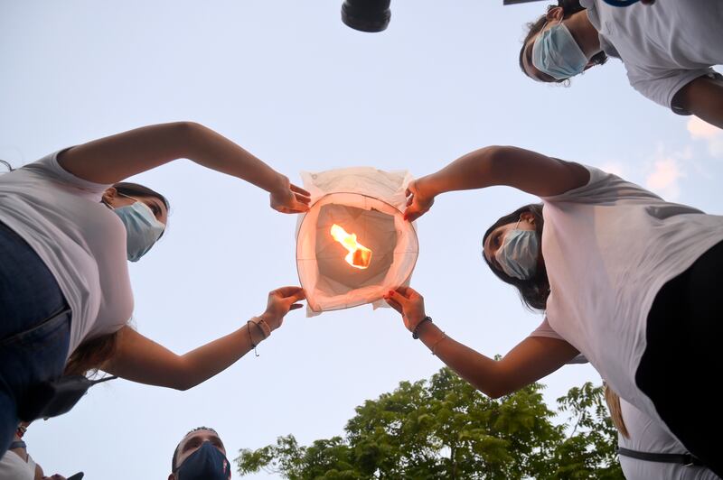 Supporters of the Free Patriotic Movement release paper lanterns to mark one year since a huge explosion in Beirut's port.