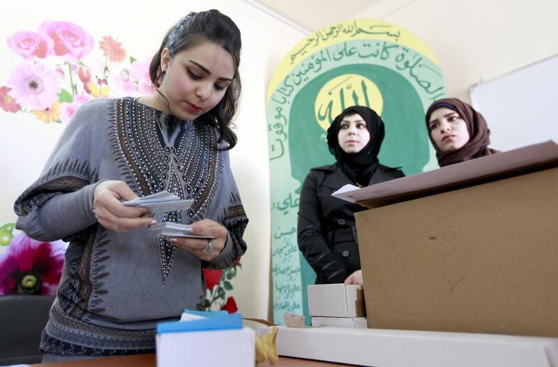 Election officials prepare to distribute voter ID cards to Iraqi citizens in Baghdad on Saturday. Karim Kadim / AP Photo