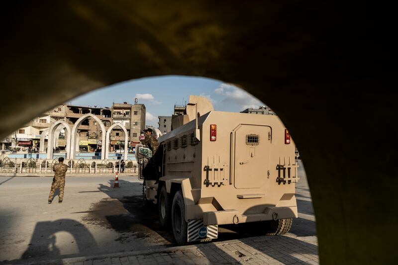 Syrian Democratic Forces fighters stand guard at Al Naeem Square, in the northern city of Raqqa. AP