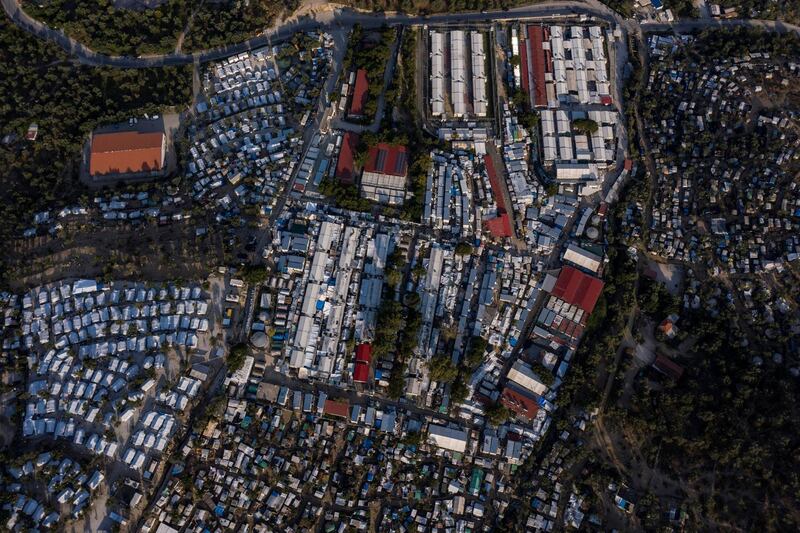 This picture taken on June 21, 2020 shows an improvised tents camp around the refugee camp of Moria in the island of Lesbos. - Greece's announcement that it was extending the coronavirus lockdown at its migrant camps until July 5, cancelling plans to lift the measures on June 22, coincided with World Refugee Day on June 27, 2020. (Photo by ARIS MESSINIS / AFP)