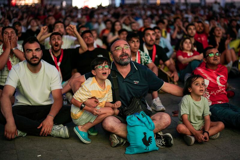 Turkish supporters in Istanbul watch their team's Euro 2024 match against Georgia being played in Dortmund, Germany.  AP