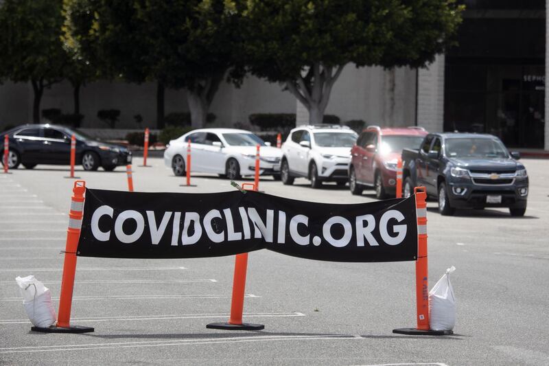 Drivers wait at a drive-through testing station in Westminster, California.  EPA