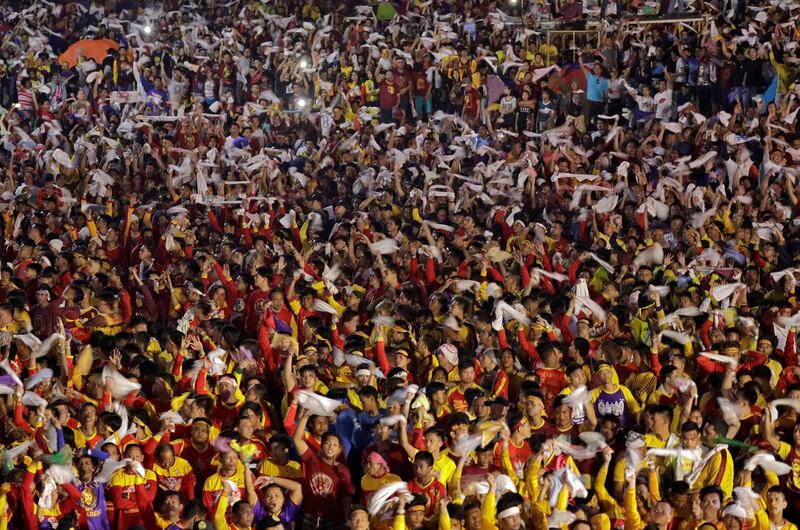 Catholic devotees flip their towels to celebrate the feast day. Reuters