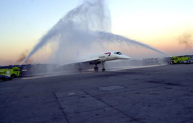 British Airways Concorde Flight 1215 passes through a water display provided by the Massport Fire Rescue Department after arriving at Logan International Airport from London 08 October, 2003 in Boston, Massachusetts. Boston is one of only three North American cities, including Washington, DC and Toronto, to receive a special farewell visit from the Concorde before the supersonic fleet is taken out of service.  (Douglas McFadd/Getty Images/AFP) FOR NEWSPAPERS AND TV USE ONLY