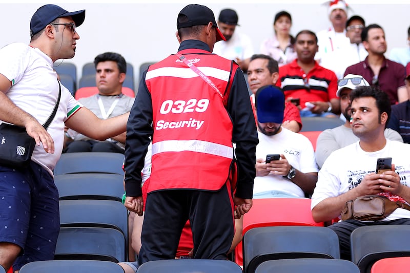 Security staff speak with Iran fans. Some fans were stopped by stadium security from bringing in Persian pre-revolutionary flags to the match against Wales. Getty Images