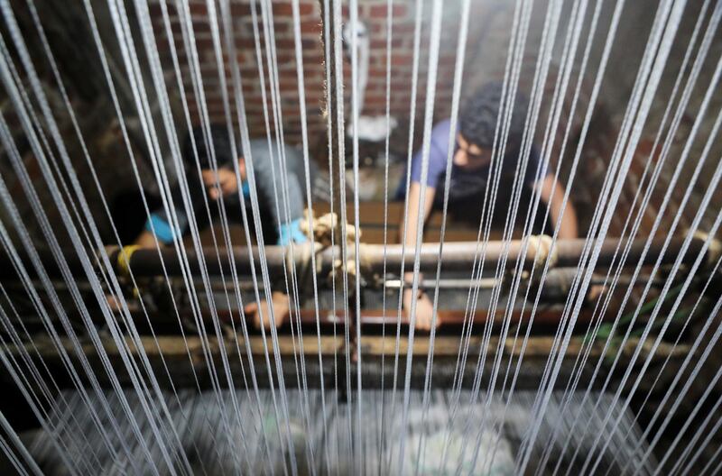 Weavers make traditional Egyptian rugs at a textile workshop in Atmida village in Dakahliya governorate, Egypt. Reuters