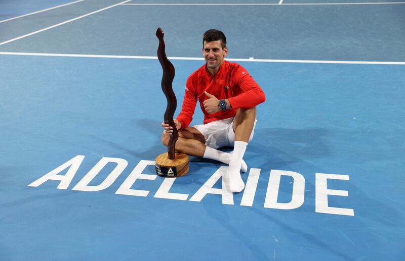 Novak Djokovic celebrates with the Adelaide International trophy. Reuters