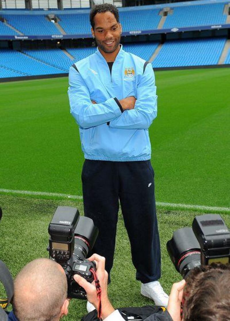 Manchester City's new signing Joleon Lescott poses for photographs during a photocall at the City of Manchester Stadium. City manager Mark Hughes has not ruled out further signing.