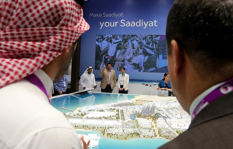 Visitors take a look at models of Saadiyat Cultural District projects at the Abu Dhabi stand in Cityscape Global 2014. Satish Kumar / The National