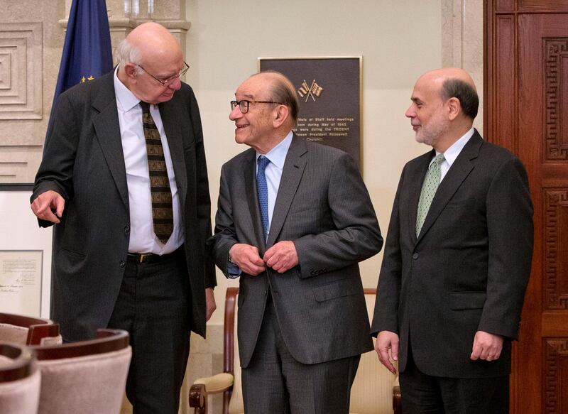 FILE - In this Dec. 16, 2013, file photo Federal Reserve Board Chairman Ben Bernanke, right, with former chairmen Paul Volcker, left, and Alan Greenspan, talk after participating in the ceremonial signing of a certificate commemorating the 100th anniversary of the signing of the Federal Reserve Act at the Federal Reserve Building in Washington. Volcker, the former Federal Reserve chairman died on Sunday, Dec. 8, 2019, according to his office, He was 92.Â (AP Photo/Pablo Martinez Monsivais, File)