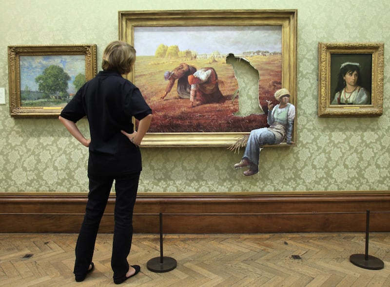 A woman admires a surprise exhibition by the artist Banksy in 2009