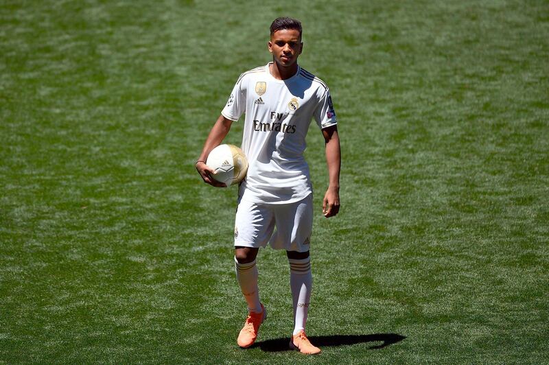 Rodrygo poses for photos during his Real Madrid unveiling. AFP