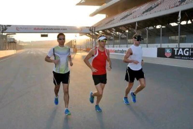 Jenson Button, centre, starts his run with trainer Mike Collier, right, and friend Richard Williams at the Dubai Autodrome. Courtesy Paul Velasco / Dubai Autodrome