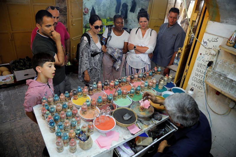 Tourists and locals look on as the craftsman creates his pieces. Reuters