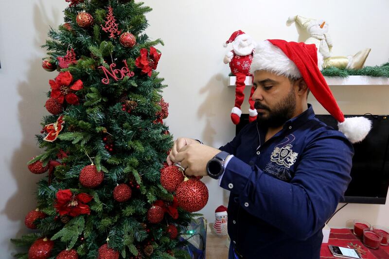 Ziad, a Muslim, prepares to decorate the Christmas tree at his home, with his wife Lamees Homidan, a Lebanese Christian, in Riyadh, Saudi Arabia. Reuters