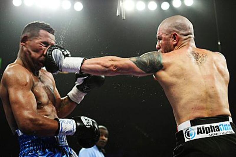 Miguel Cotto, right, connects with a left-hook during his WBA super-welterweight defence against Ricardo Mayorga.