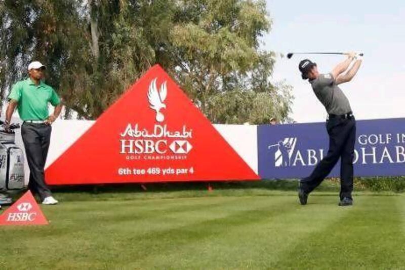 Rory McIlroy, above right, started off well, winning the Abu Dhabi HSBC Golf Championship, .